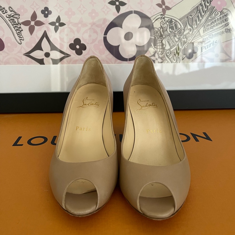Christian Louboutin Nude leather peep toe wedge.